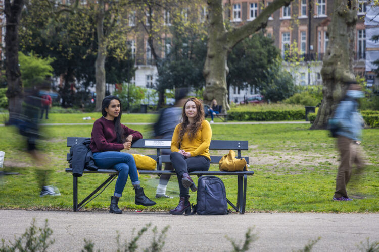 Image of two women discussing Mental Health on a park bench in Central London